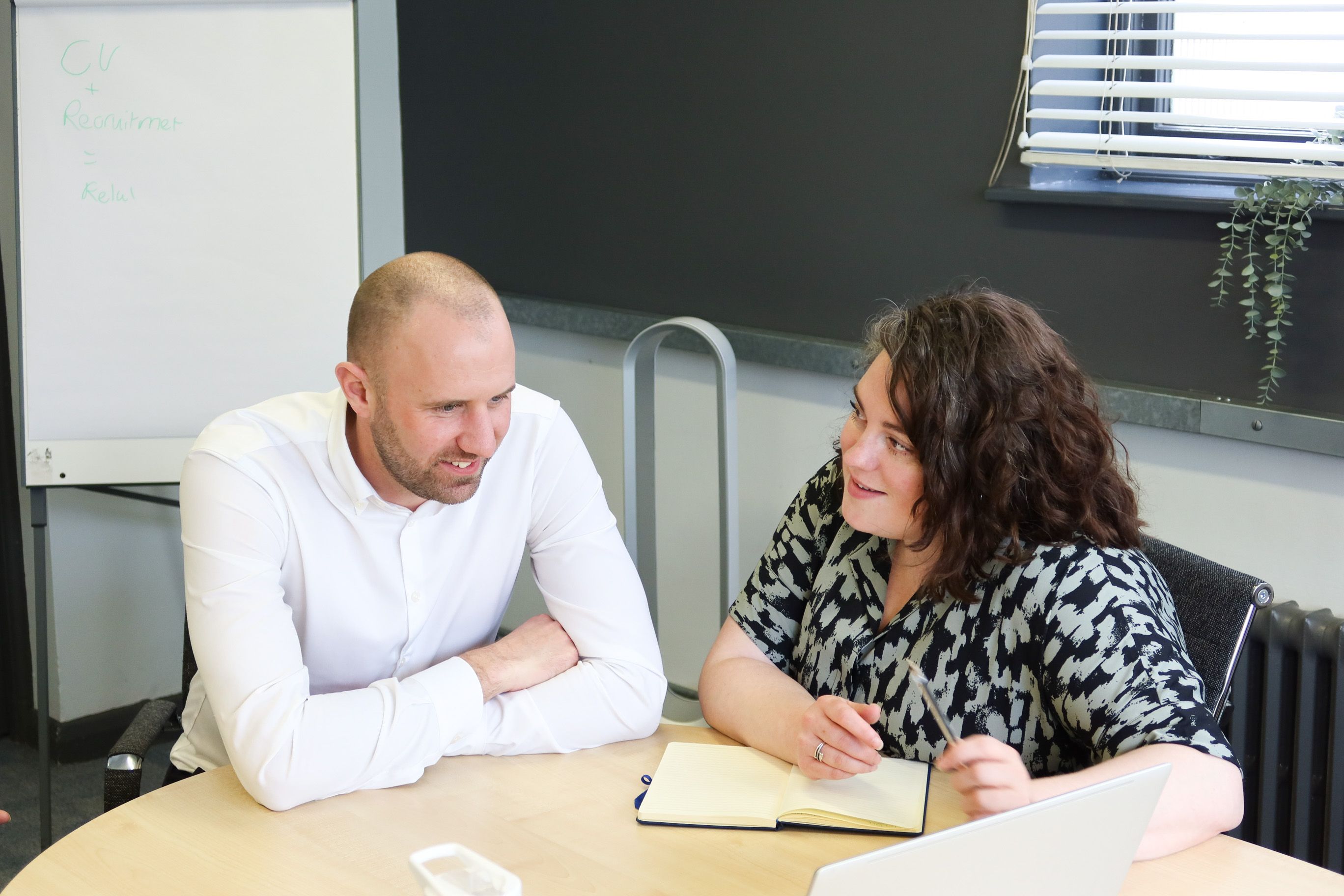 Signet Resources consultants collaborate on CV strategies for recruitment, conveying a relaxed yet focused work atmosphere.